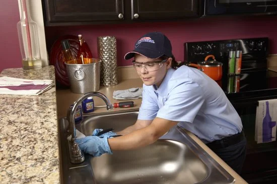 Water Line Repair & Installation - Plumbing Technician Fixing The Water Line Of the Water Sink