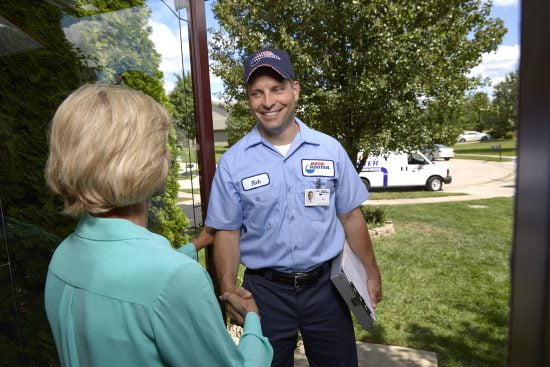 Plumbing Technician Shaking Hand With Lady - Garbage Disposal Replacement