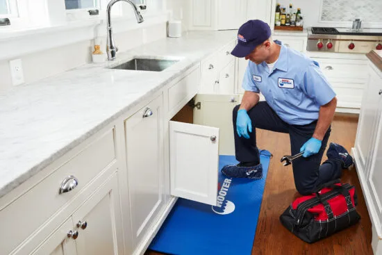 Coupons plumbing tech working under sink roto rooter